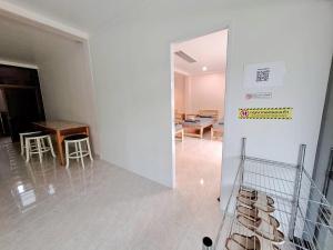 a hallway with a table and chairs in a building at Padang Besar In front of Border Private room & Hostel in Sathani Padang Besa