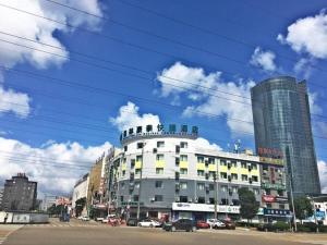 a large building on a city street with buildings at GreenTree Inn Ningbo Ninghai Beidou North Road Express Hotel in Shang-ts'un