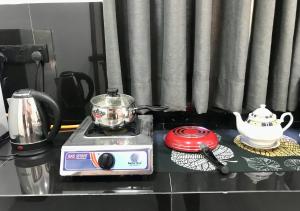 a kitchen counter with a tea pot and a toaster at Amelia Villa in Gandara West