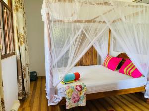 En eller flere senge i et værelse på Romaclan Villa