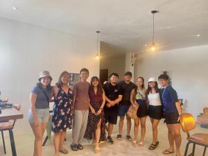 a group of people posing for a picture in a room at Isa- Hostel in Panglao Island