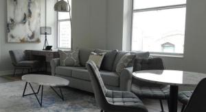 a living room with a couch and chairs and a table at The Chicago Hotel Collection Millennium Park in Chicago