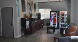 a living room with a television and a living room with a couch at Las Palmas Hotel in Los Angeles