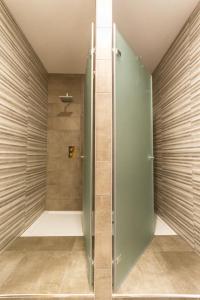 a shower with a glass door in a bathroom at Hostel D'Avenida in Vila Praia de Âncora