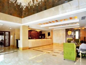 un vestíbulo de un hotel con gente sentada en las mesas en Zhongshan Louis Hotel, en Zhongshan