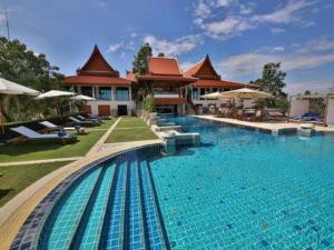 a large swimming pool in front of a house at Baan Souchada Resort & Spa in Ban Sap Muang
