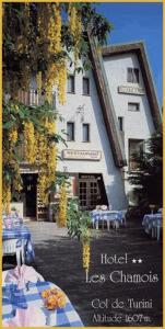 
a restaurant with a sign on the side of the building at Hôtel Les Chamois in La Bollène-Vésubie
