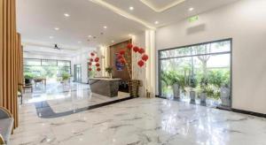 a lobby with a large marble floor with red balloons at HON BA LAGI BEACH RESORT in La Gi +163 photos