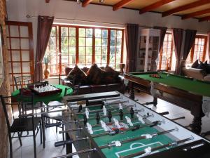 a living room with two pool tables and a couch at House on York in Johannesburg