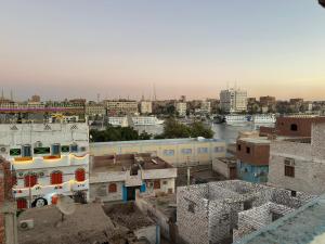 a view of a city with buildings and a river at SolNest Guest House in Aswan +11 photos