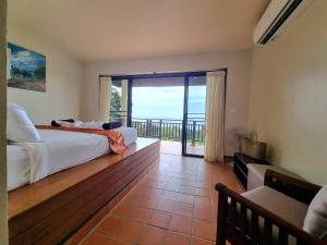 a bedroom with two beds and a balcony with a view at The Great Escape Pool Seaview Villa in Ko Lanta +23 photos