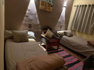 a living room with two beds and a christmas tree at Nasser Nubian Guest House in Jazīrat Aswān