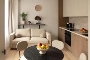 a living room with a table with a bowl of fruit on it at Apartament Perła w Kłodzku 2 in Kłodzko