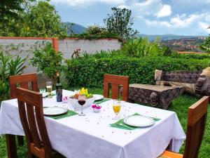 a table with a white table cloth and glasses of wine at 5 Swiss Hotel in Kigali