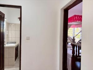 een badkamer met een spiegel en een keuken met een wastafel bij Diamond Luxury Homes in Watamu +27 foto's