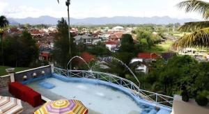 a swimming pool with a view of a city at Campago Resort Hotel in Bukittinggi