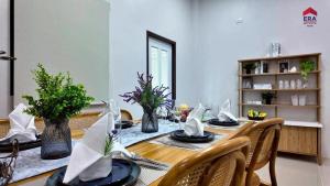 a dining room with a table with napkins on it at Aqua Pool villa, Krabi in Ban Nong Thale