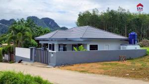 a house with a fence in front of it at Aqua Pool villa, Krabi in Ban Nong Thale