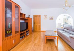 a living room with a couch and a tv at Marble Arch Home in St Julian's