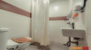 a bathroom with a toilet and a sink at Front One Hotel Jayapura in Jayapura +34 photos