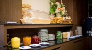 a table with plates and dishes on top of a buffet at Silayok Grand Hotel in Tak