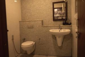 a bathroom with a toilet and a sink at Hotel UR Comforts Jayanagar in Bengaluru +41 photos