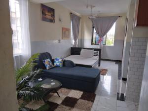 a living room with a couch and a table at House 139 Vescon one in Roka