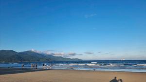 a group of people standing on the beach at Full House Hotel Apartment in Danang