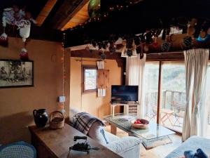 a living room with a couch and a table at Casasdetrevijano Mirador de Mateo in Soto en Cameros