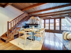 a dining room with a table and chairs and a staircase at ADELAIDA de Alma de Nieve in Baqueira-Beret