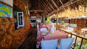 a restaurant with a table and chairs in a room at Forra Pattaya Sea View Bungalow in Ko Lipe