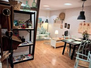 a living room with a table and a dining room at Logrocity Corazon de Logroño PARKING PRIVADO GRATIS in Logroño