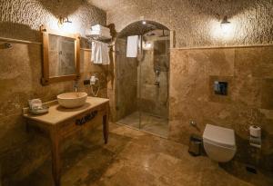 a bathroom with a sink and a shower and a toilet at Design Cave Hotel in Goreme +97 photos