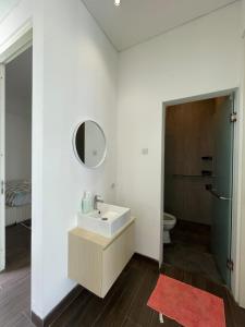 a bathroom with a sink and a mirror and a toilet at Orlando Hill Villa in Ngadisari +37 photos
