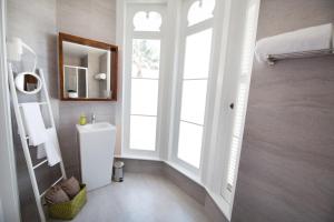 a bathroom with a sink and a window at Casa das Palmeiras Charming House - Azores 1901 in Ponta Delgada