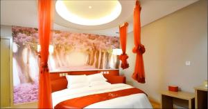 a bedroom with a canopy bed with orange curtains at Thank Inn Hotel He'nan Xuchang Railway Station Qiyi Road Caowei Ancient Town in Xuchang