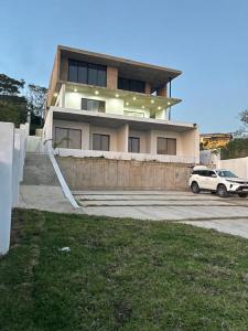 Un coche blanco aparcado delante de una casa en Azure Escape- La Mercy B&B, en La Mercy