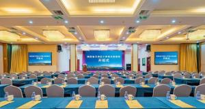 a conference room with blue tables and chairs at Xiamen Plaza Hotel in Xiamen