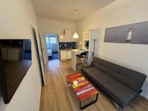 a living room with a couch and a table at Klockerhof Appartements I Rooms in Hart bei Graz