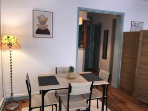 a dining room table and chairs in a room at l'Aiglon in LʼAigle +4 photos