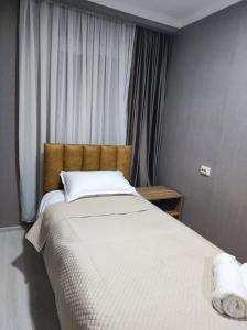 a bedroom with a large bed with white sheets at White Peaks in Mestia +32 photos
