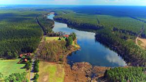 an aerial view of a river with trees and a house at Dom ukryty przed światem - Szeroki Bór in Ruciane-Nida