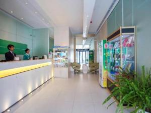 a lobby of a store with two men standing at a counter at Jinjiang Inn Weihai Liugong Island Scenic Spot Shopping Market in Weihai