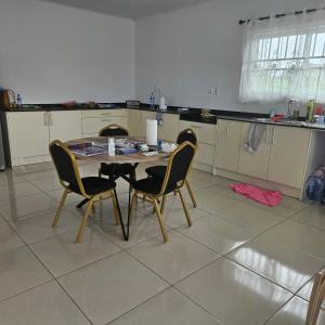 eine Küche mit Tisch und Stühlen in einem Zimmer in der Unterkunft Jawala Mansion in Paramaribo