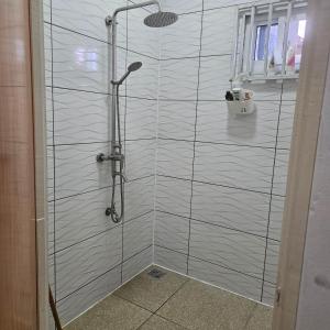 a shower with a glass walled shower stall with at Jawala Mansion in Paramaribo +6 photos
