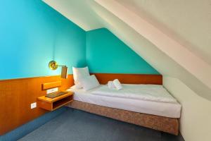 Postel nebo postele na pokoji v ubytování AR Boutique Hotel Mannheim + 55 fotografií