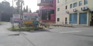 un cartel en un estacionamiento al lado de un edificio en Hotel Centrepoint (Self Check In After 5PM), en Kuala Lipis