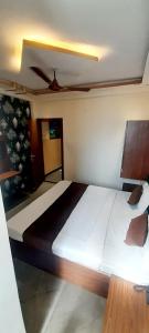 a bedroom with a large bed with a ceiling at HOTEL RAJBHOG indore in Indore +5 photos