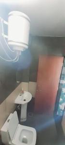 a bathroom with a white toilet and a sink at HOTEL RAJBHOG indore in Indore