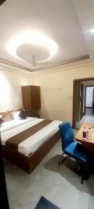 a bedroom with a bed and a desk and a chair at HOTEL RAJBHOG indore in Indore